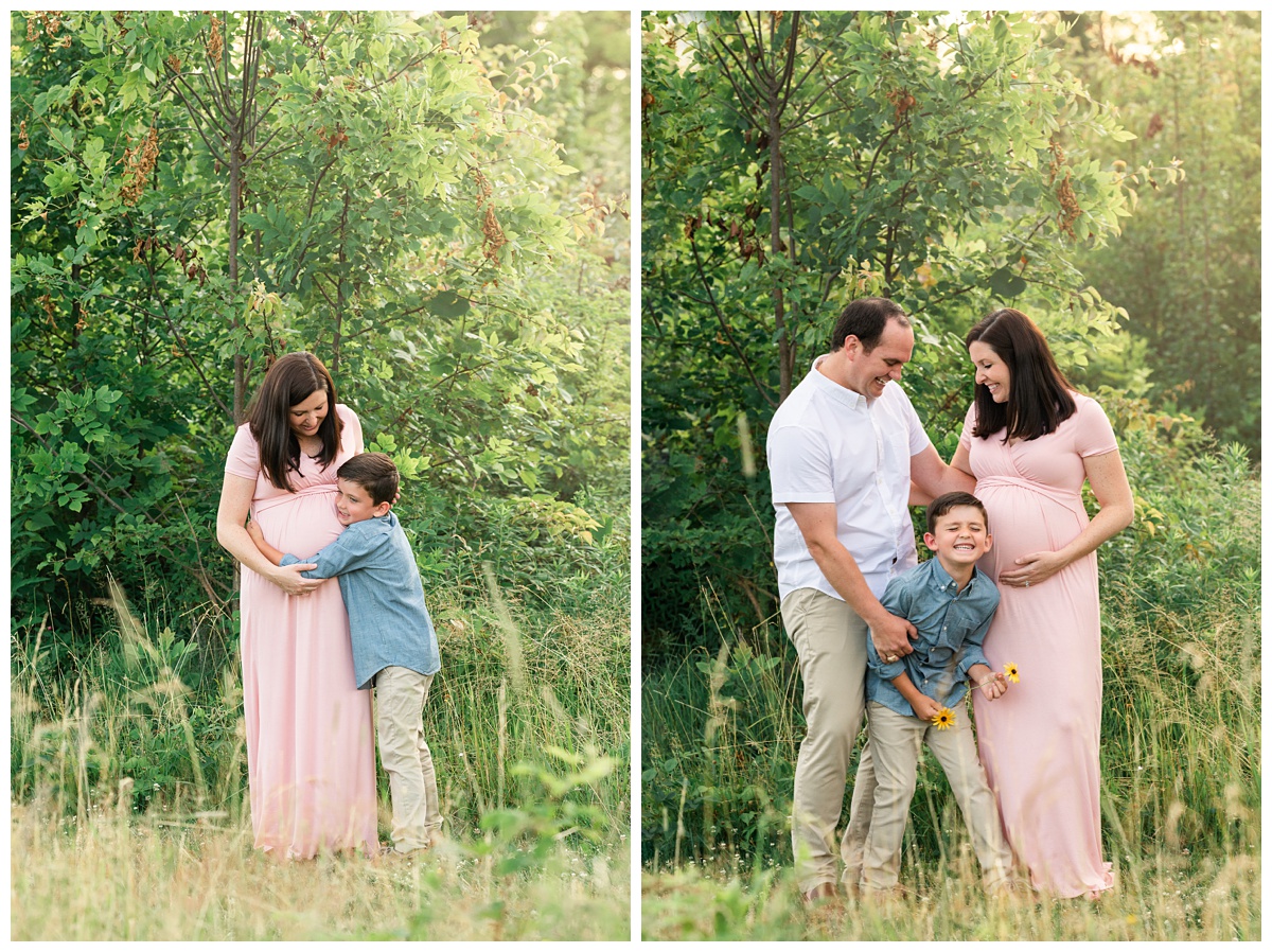 best maternity photographer mom and dad tickle young son in blue shirt in a green field