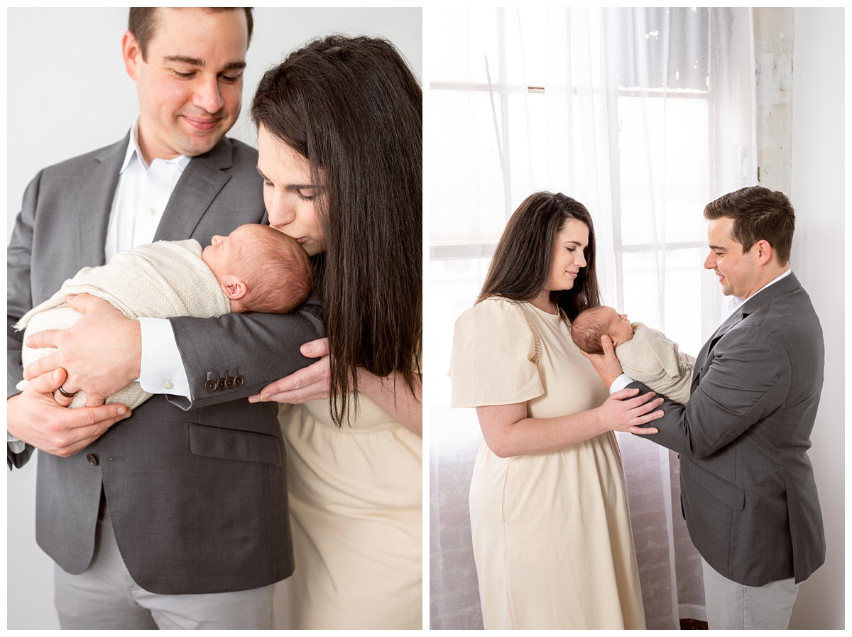 Top Columbus Ohio Newborn Photographer mother kisses newborn boy in tan wrap held by dad in dinner jacket