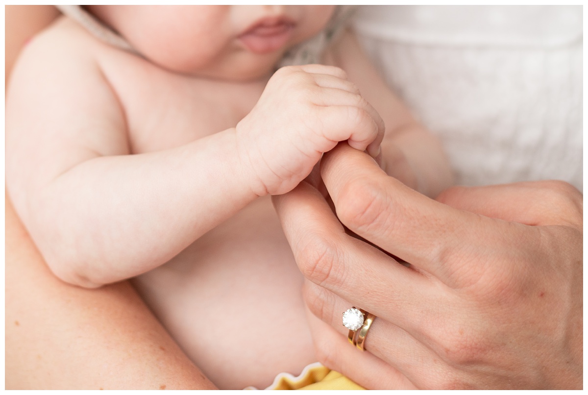 Professional Baby Photographer Columbus Ohio little boy grasps mothers hand with wedding ring on
