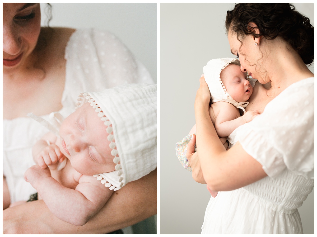 Professional Baby Photographer Columbus Ohio mom snuggles little girl in white bonnet close to her chest