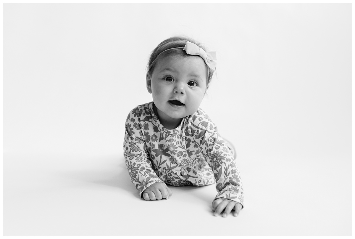 Classic Baby Portrait Photographer Columbus Ohio little girl smiles at camera in black and white