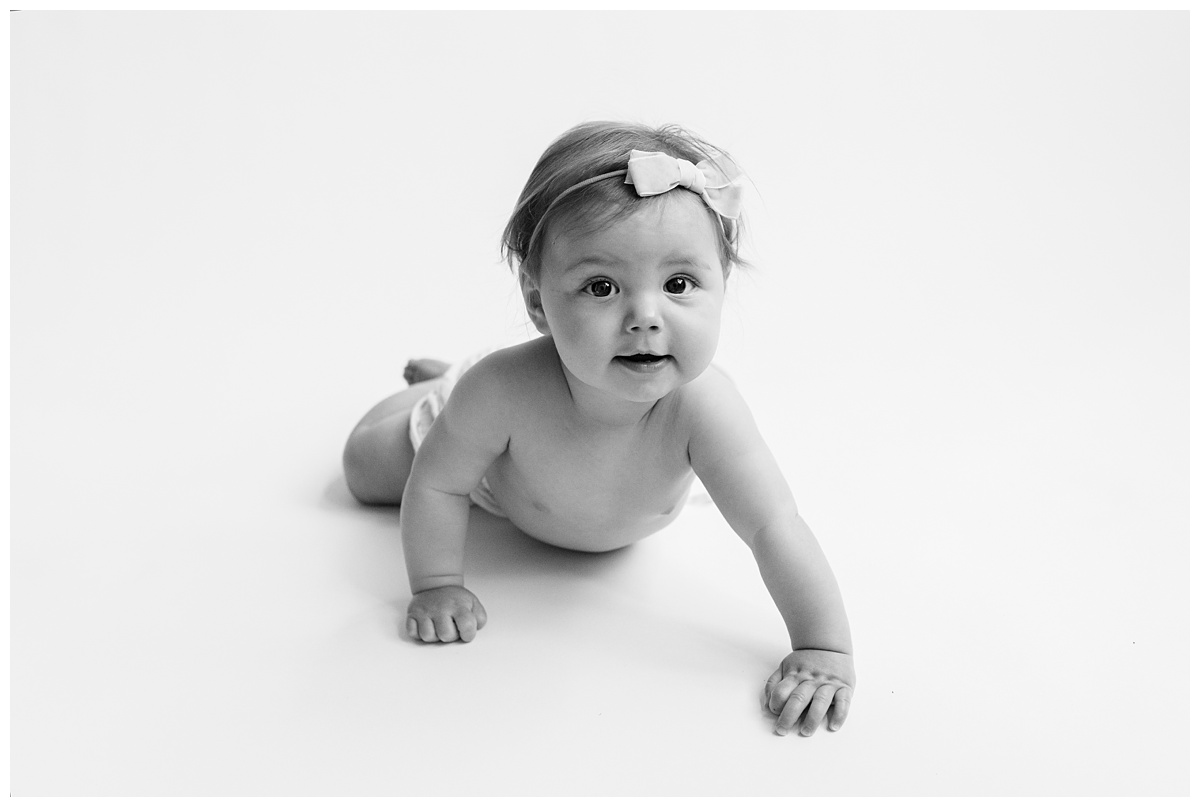 Classic Baby Portrait Photographer Columbus Ohio six month old pushes up with bow and bloomers on