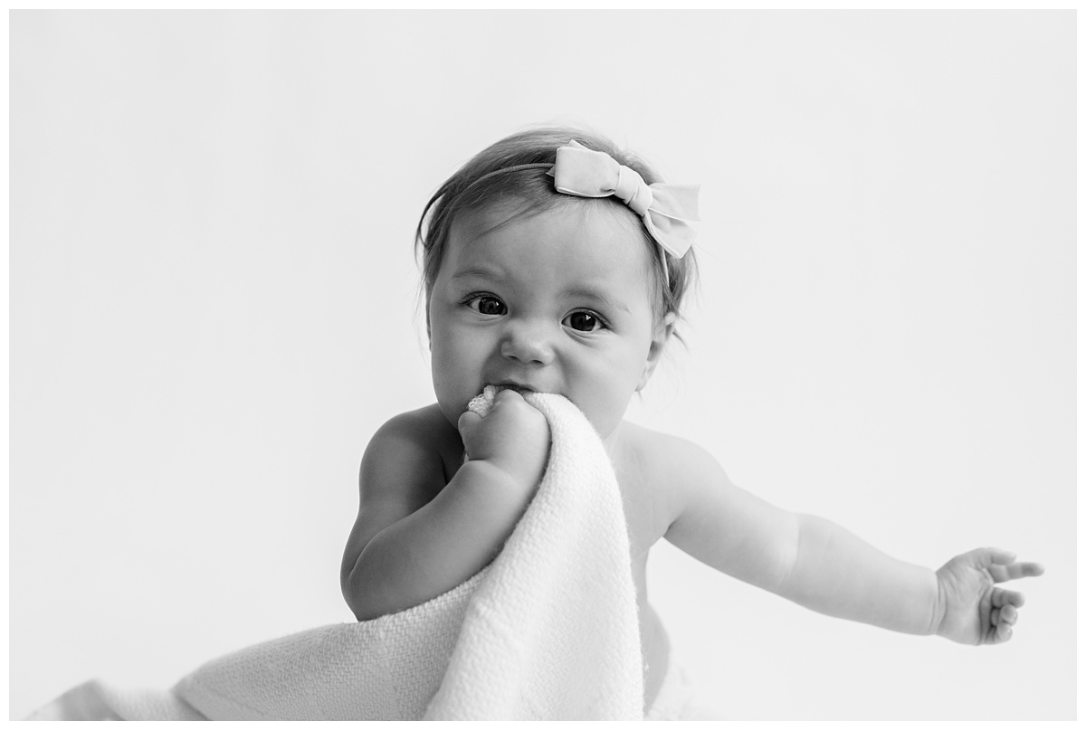 Classic Baby Portrait Photographer Columbus Ohio baby plays with her blanket portrait