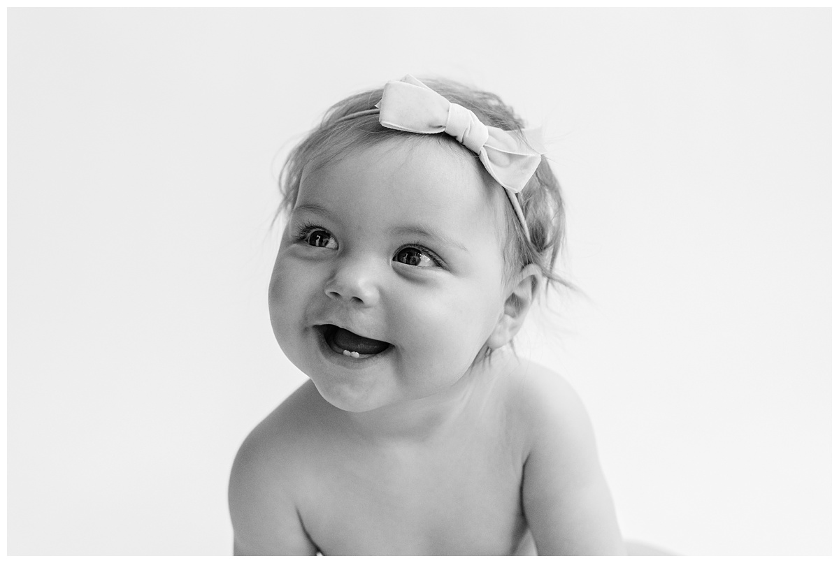 Classic Baby Portrait Photographer Columbus Ohio baby smiles with bow in black and white