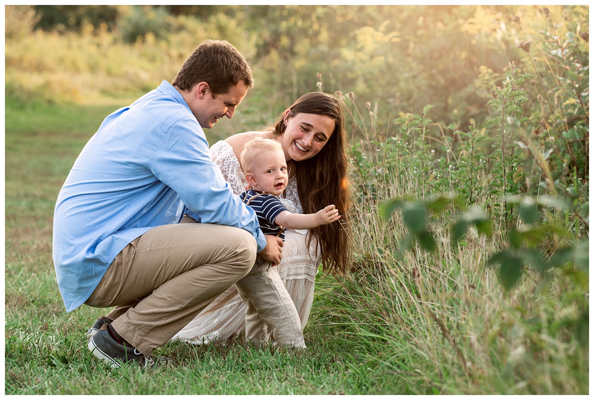 Summer Field Cake Smash baby boy grabs wildflowers with parents
