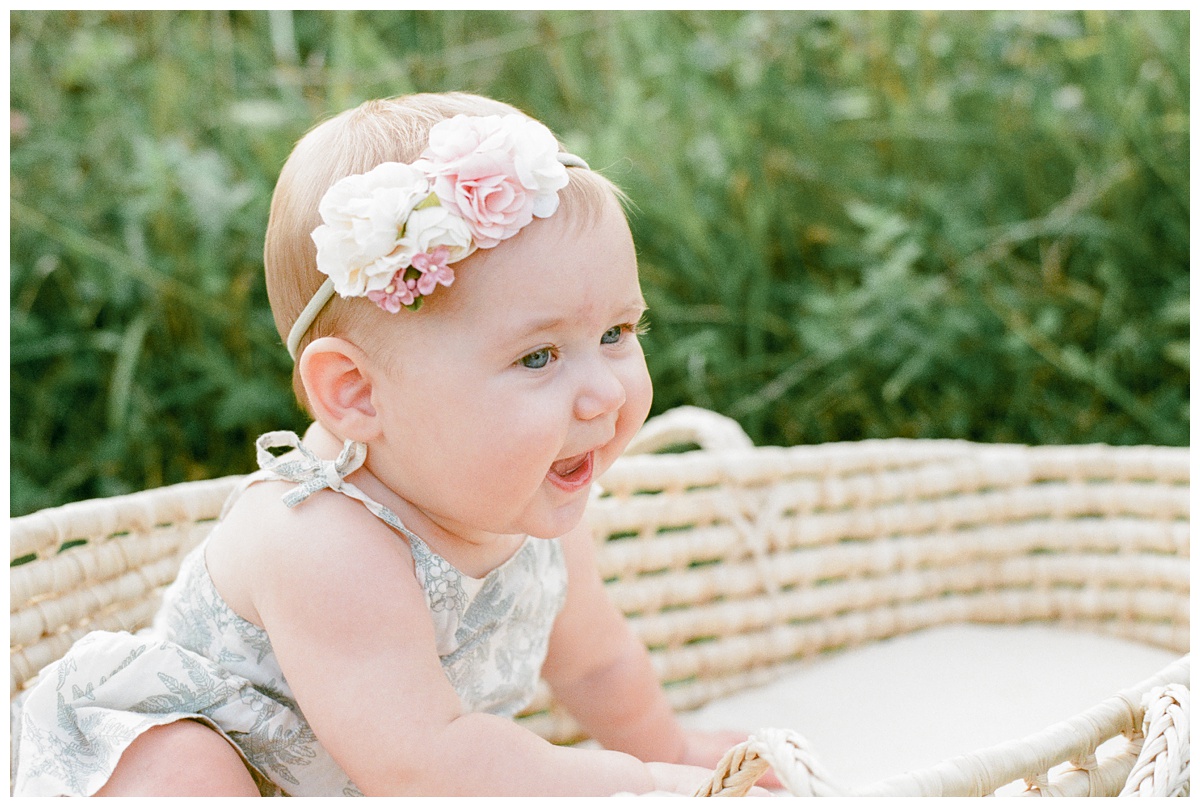 Summer field milestone session film portrait of baby girl with flower headband