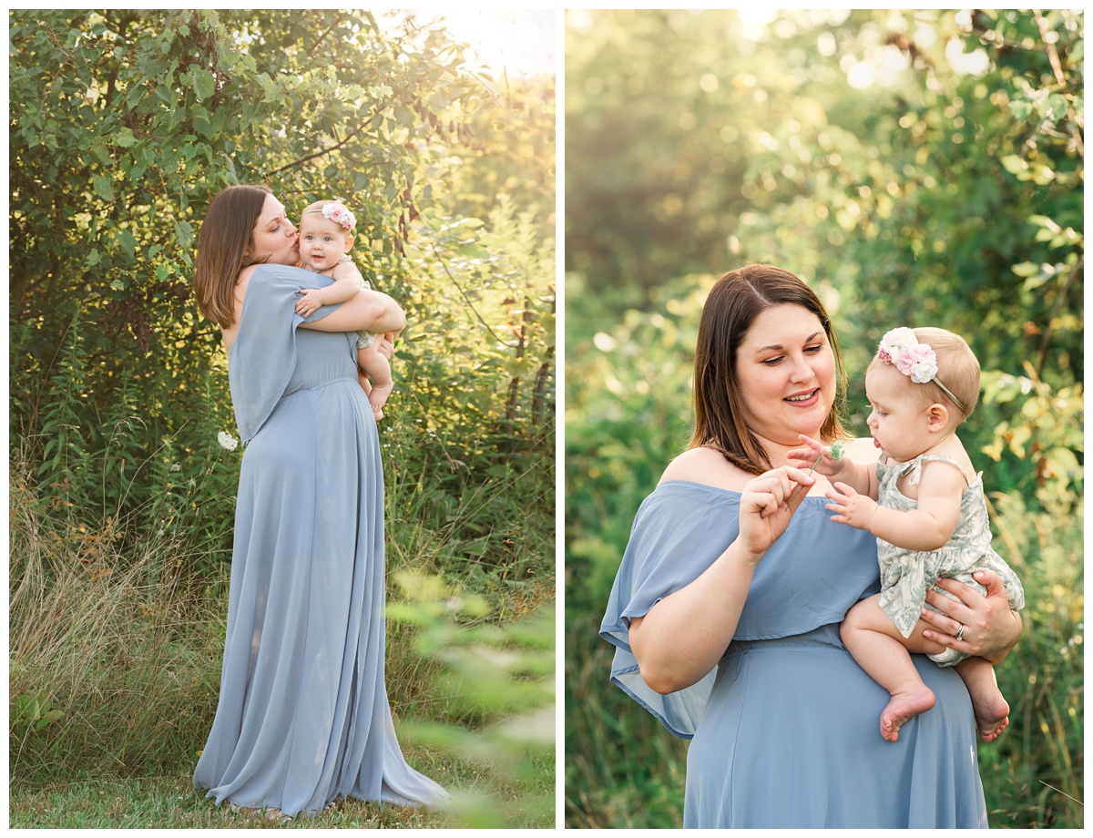 Summer field milestone session mom in blue dress kisses daughters cheek 