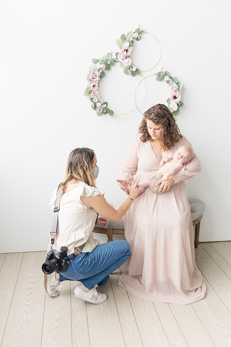 photographer poses baby in moms arms