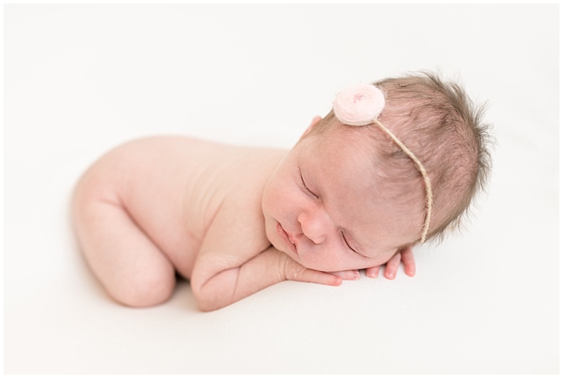 newborn girl sleeps with pink headband